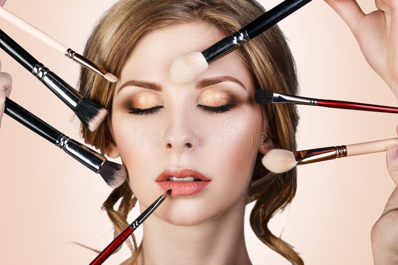 Many Hands Applying Make-up To Glamour Woman. Stock Photo - Image of