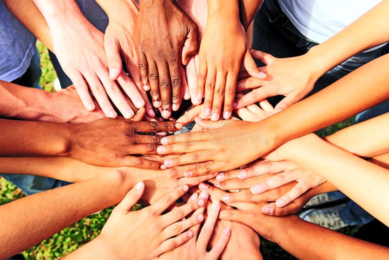 Many hands together: group of people joining hands