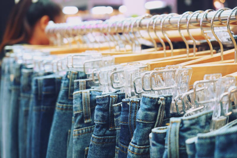 Jeans Hanging On Rack In Clothes Shop Stock Photo Image of