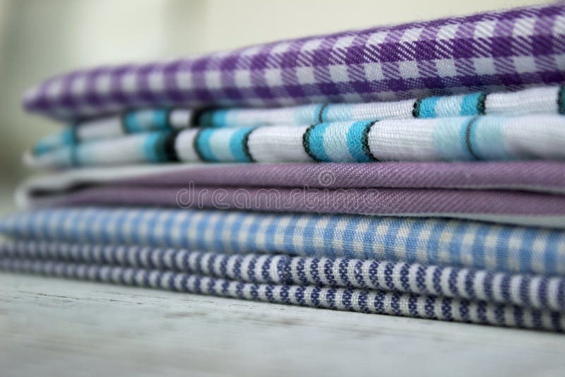 Many kinds of cotton fabrics in stripes and cage on a lilac background.