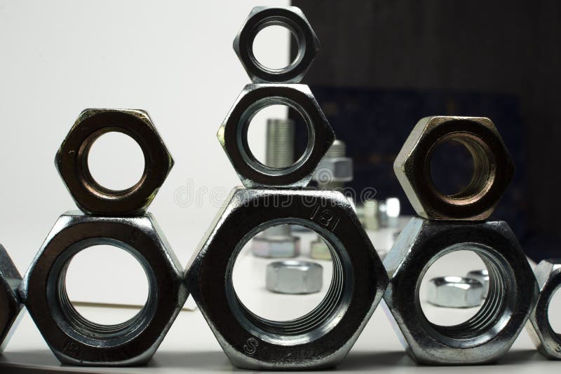 Many metal nuts stacked on stock image. Image of steel 204874011