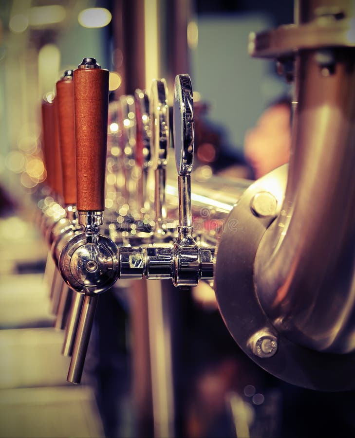 Many Metal Taps with the Wooden Handle for Draft Beer Stock Image