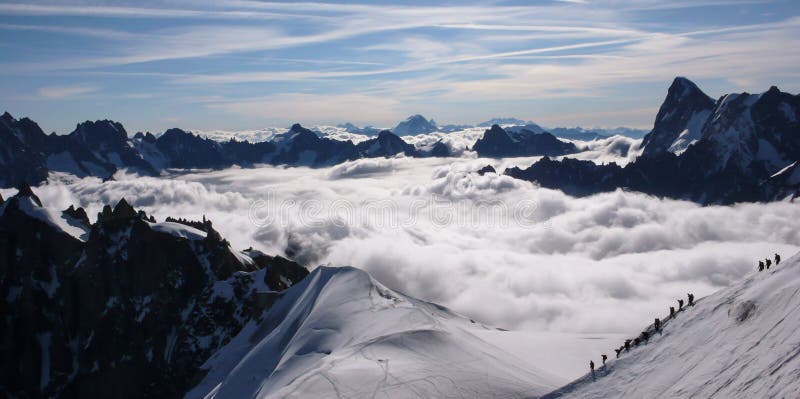 Mountain climbers descending from the Aiguille du Midi into the Mont Blanc mountains near Chamonix in the French Alps. Mountain climbers descending from the Aiguille du Midi into the Mont Blanc mountains near Chamonix in the French Alps