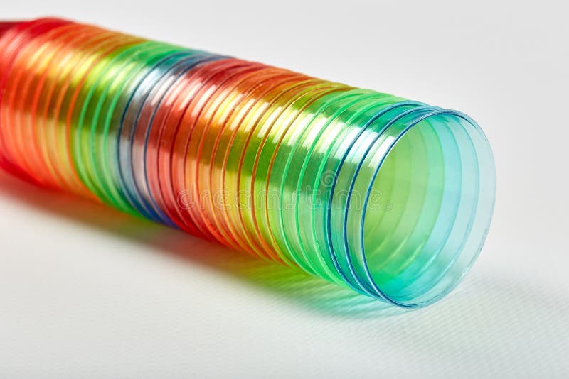 Many Multicolored Rainbow Colored Plastic Glasses are Stacked Together