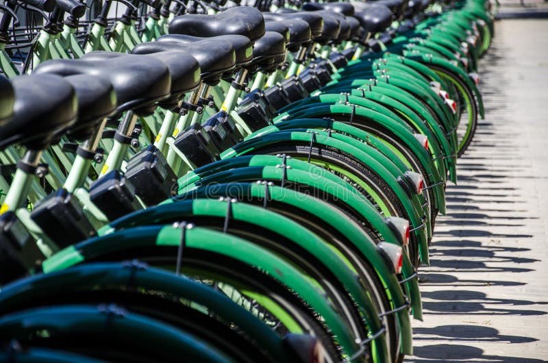 Green bikes stock image. Image of bicycles, shared, wind - 129359573