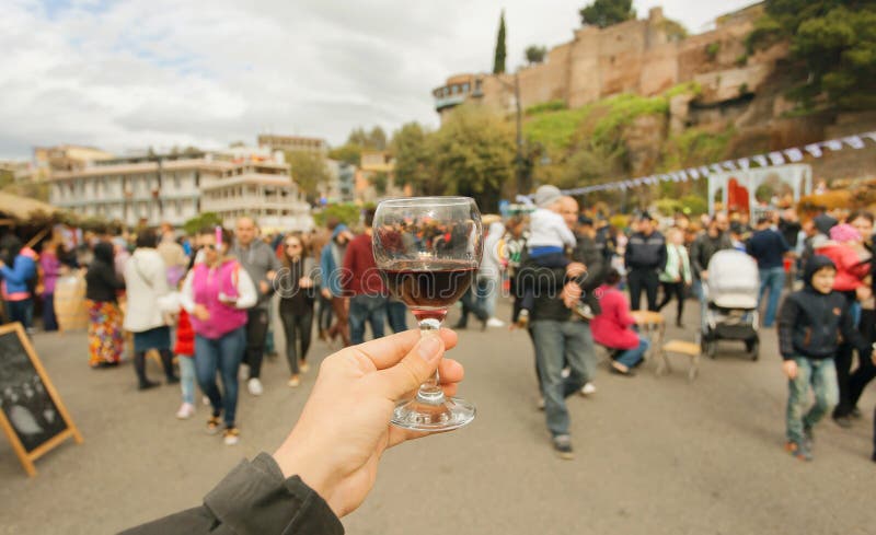 Many people with families walking the celebration streets with wine during festival Tbilisoba. Tbilisi, Georgia country