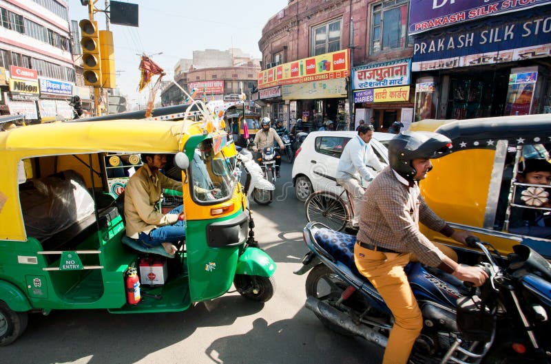 JAIPUR, INDIA: Many private yellow-green rickshaw cabs and cars on the street traffic jam in indian town. Jaipur, with population 6,664000 people, is a capital of Rajasthan