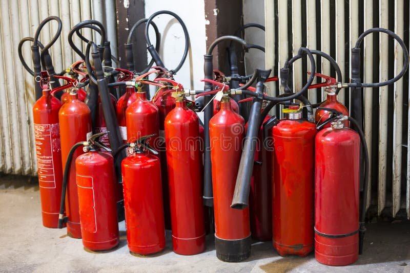 Many red fire extinguishers stock photos