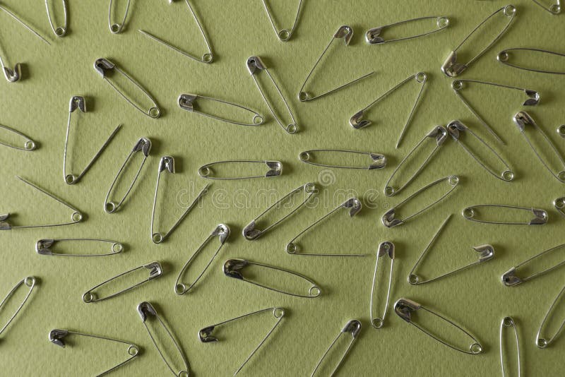Many Safety Pins on Green Background, Flat Lay Stock Photo Image of