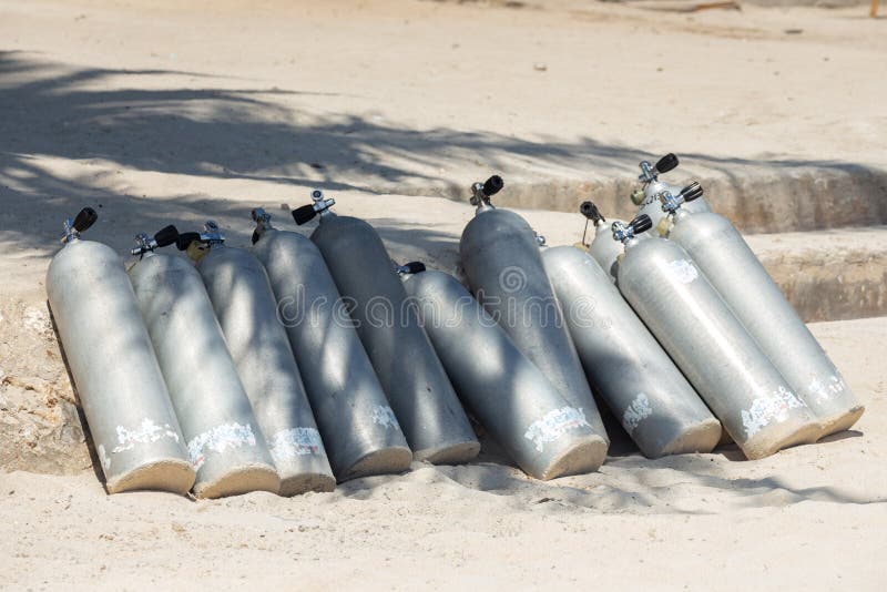 Many scuba diving air oxygen tanks cylinders at the beach royalty free stock photo Many scuba diving air oxygen tanks cylinders at the beach royalty free stock photo
