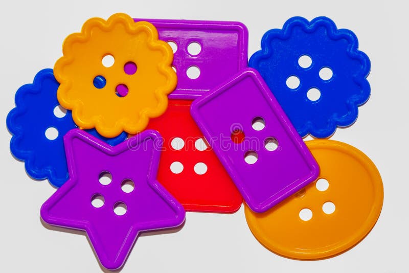 How To Sew on a Button with Four Holes. Colored Buttons on Yellow Felt