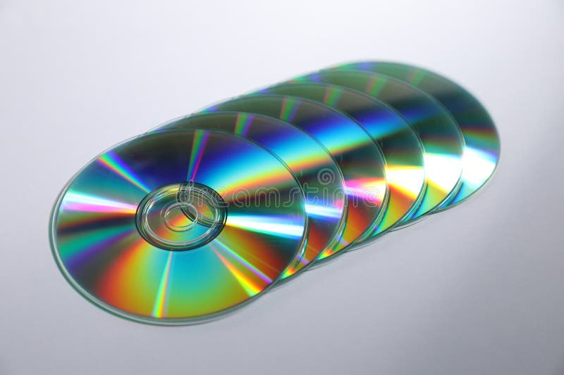 Many shiny compact discs on light background stock photos