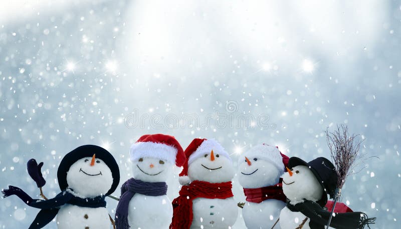 Many snowmen standing in winter Christmas landscape