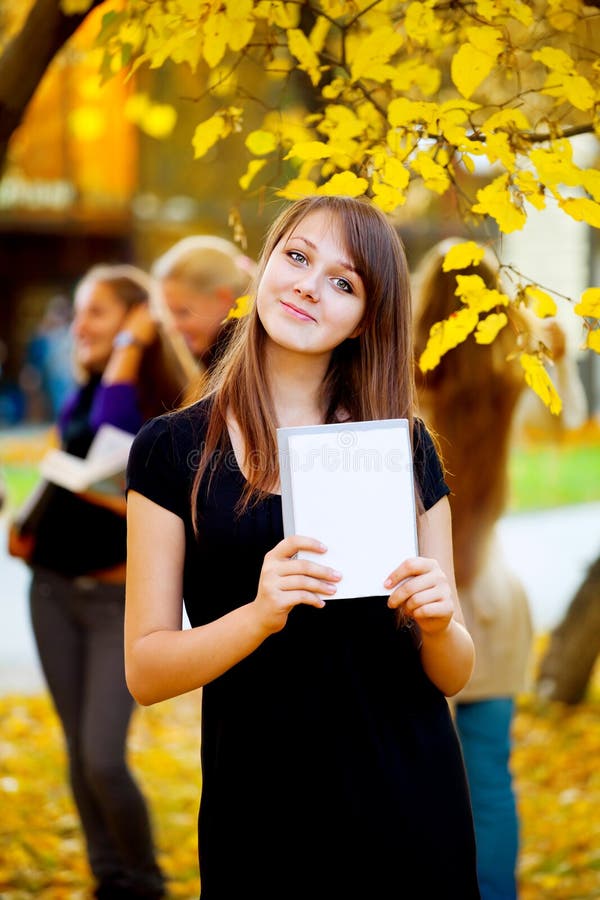 Molte ragazze nel parco autunno con i libri.