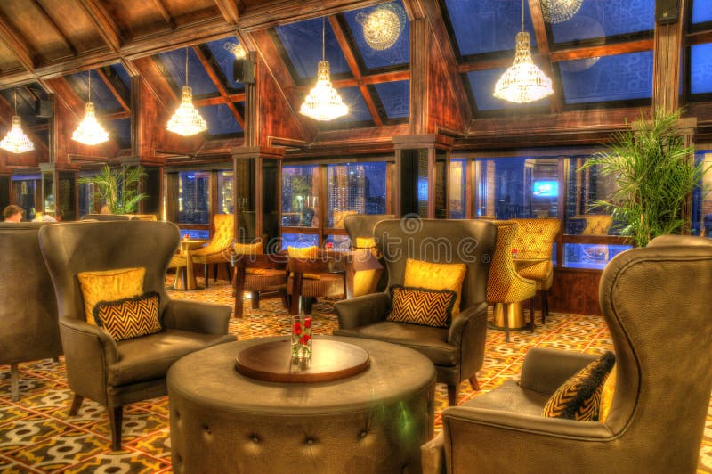 Tables and Lounge Chairs with Hanging Lights in a Comfortable Lounge