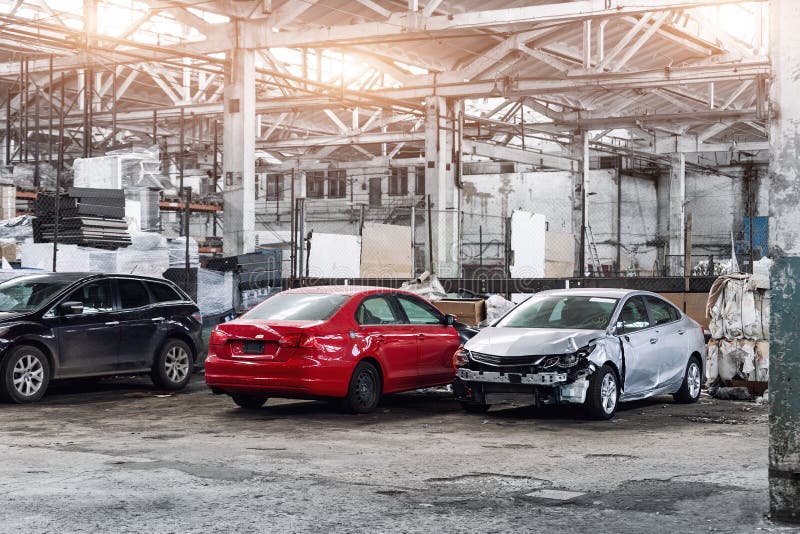 Many unknown altered wrecked car after traffic accident crash at restore service maintenance station garage indoor