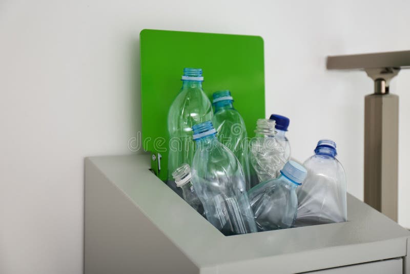 Many Used Plastic Bottles in Metal Bin Indoors, Closeup. Recycling