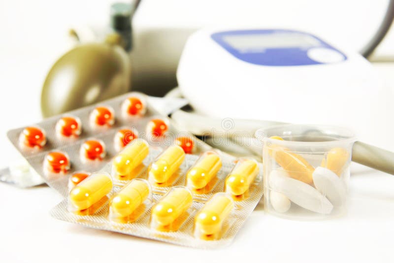 Many Various Drugs and Blood Pressure Measurement Device Stock Photo