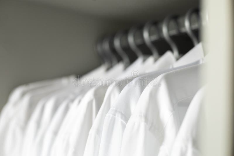 https://thumbs.dreamstime.com/b/many-white-collar-clean-male-shirts-hangers-cupboard-business-clothes-storage-organization-closeup-many-white-collar-clean-male-262685049.jpg