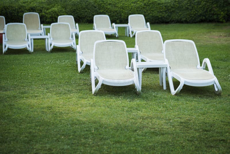 Many white deck chairs stock image. Image of grass, tourism 154989443