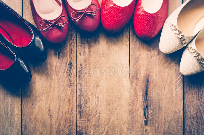 Many women`s shoes are laid on wooden floors.