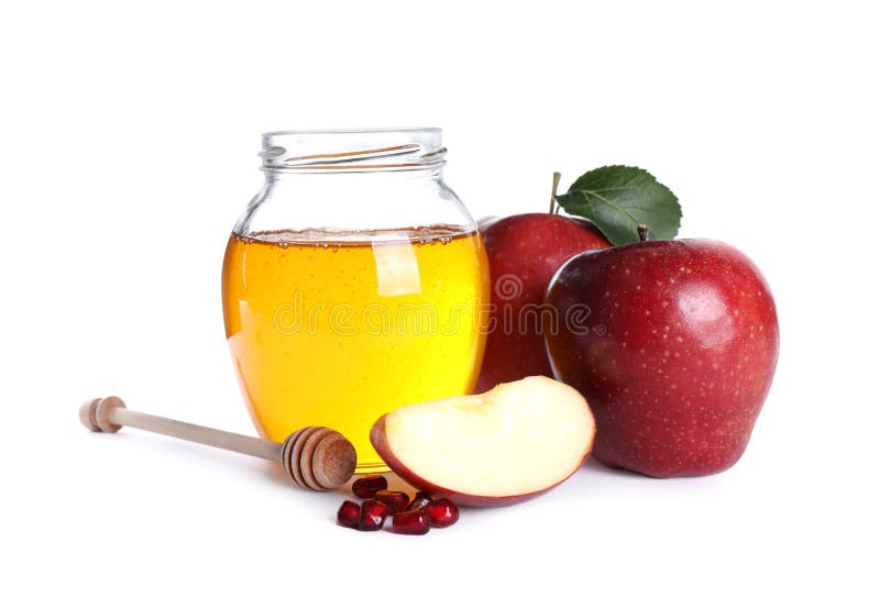 Honey, apples and pomegranate seeds on white background. Rosh Hashanah holiday. Honey, apples and pomegranate seeds on white background. Rosh Hashanah holiday