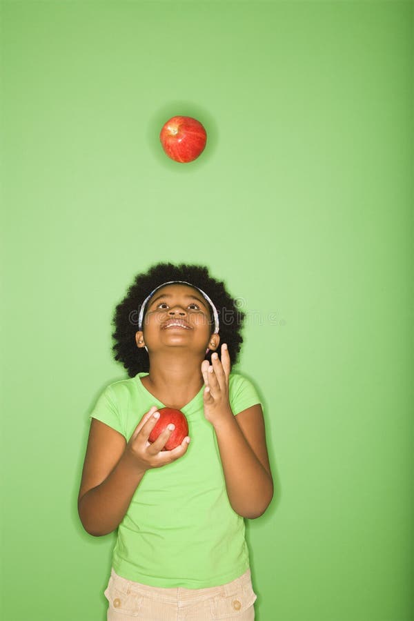 Manzanas que hacen juegos malabares de la muchacha.