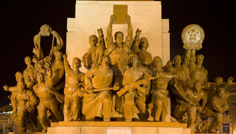 Mao Statue Heroes at the Base of Statue Zhongshan Square Shenyang, Liaoning province, China at Night. Built in 1969 during the Cultural Revolution. One hero is holding up copy of a book on the thoughts of Mao Zedong. Mao Statue Heroes at the Base of Statue Zhongshan Square Shenyang, Liaoning province, China at Night. Built in 1969 during the Cultural Revolution. One hero is holding up copy of a book on the thoughts of Mao Zedong.