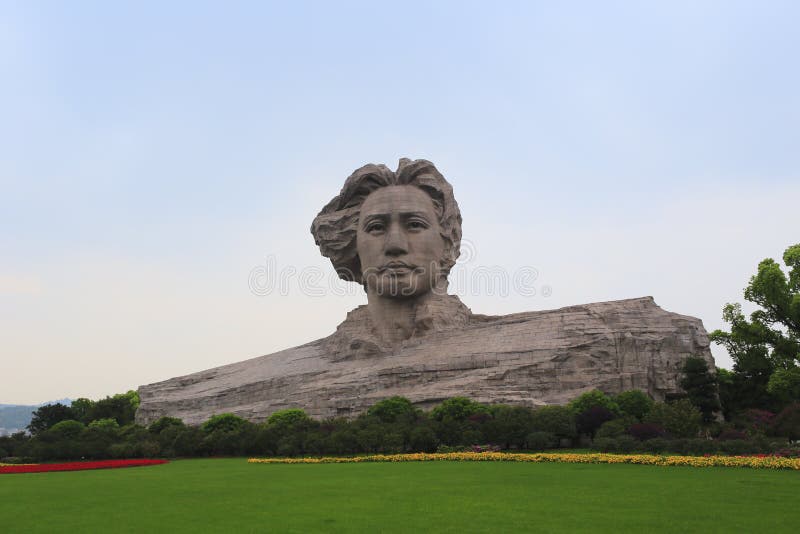 Young mao zedong sculpture in orange chau tau,changsha city, hunan province, china. the statue of young mao zedong in 1925 is 32 meters high, 83 meters long, 41 meters wide, the base is 3500 m2. statue made of more than 8000 pieces of red granite mosaic, with a total weight of about 2,000 tons.