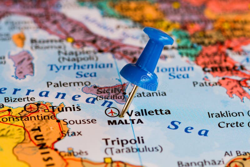 Map of Malta with a blue pushpin stuck. Atlas book stock images, royalty-free photos and pictures