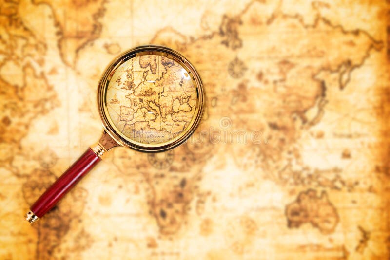 Old map with an magnifying glass exploring it. Vintage travel background. Old map with an magnifying glass exploring it. Vintage travel background