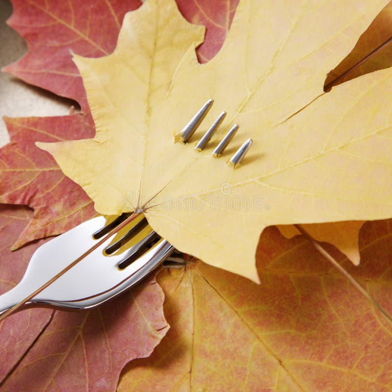 Maple leaf pierced by fork.