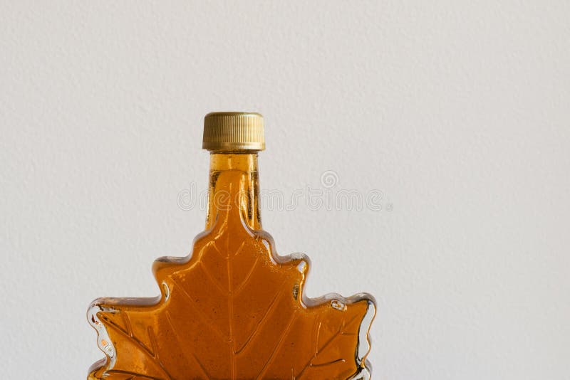 Maple syrup in leaf bottle stock photo. Image of glass 135537516
