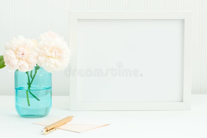 White 8x10 empty frame mockup with David Austin roses in a blue mason jar. Features a blush card and gold envelope. Feminine horizontal frame mockup. Landscape orientation. White 8x10 empty frame mockup with David Austin roses in a blue mason jar. Features a blush card and gold envelope. Feminine horizontal frame mockup. Landscape orientation.