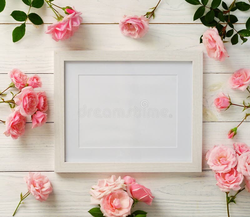 Poster frame mockup, top view, pink roses on white wooden background. Holiday concept. Copy space. Poster frame mockup, top view, pink roses on white wooden background. Holiday concept. Copy space