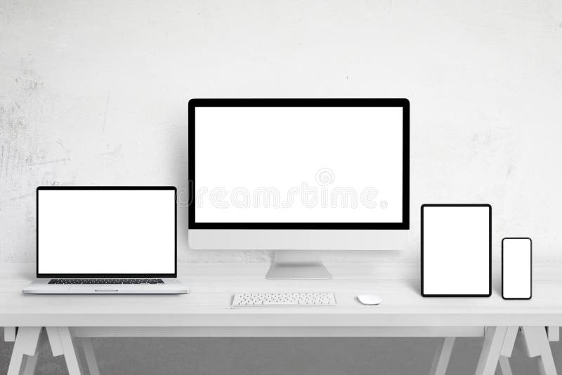 Responsive devices mockup for web site design promotion on different display sizes. Isolated white screens. White wooden table. Responsive devices mockup for web site design promotion on different display sizes. Isolated white screens. White wooden table