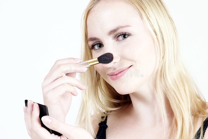 Young blond girl doing make-up. Young blond girl doing make-up