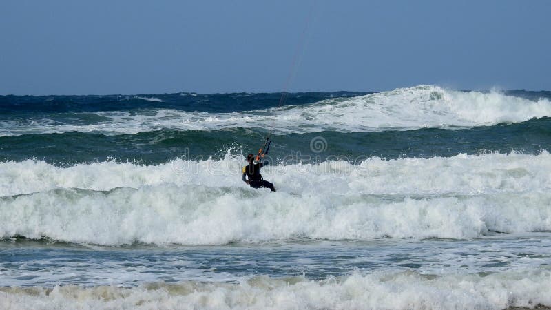 Mediterranean Sea. Israel. The coast near Haifa. The sea is storming. But there are daredevils who fly through the waves. Using a sail. Mediterranean Sea. Israel. The coast near Haifa. The sea is storming. But there are daredevils who fly through the waves. Using a sail.