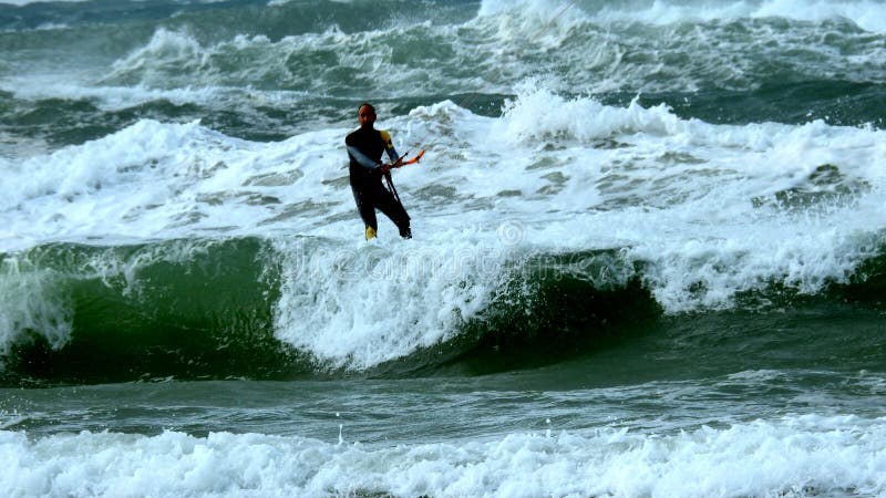 Mediterranean Sea. Israel. The coast near Haifa. The sea is storming. But there are daredevils who fly through the waves. Using a sail. Mediterranean Sea. Israel. The coast near Haifa. The sea is storming. But there are daredevils who fly through the waves. Using a sail.