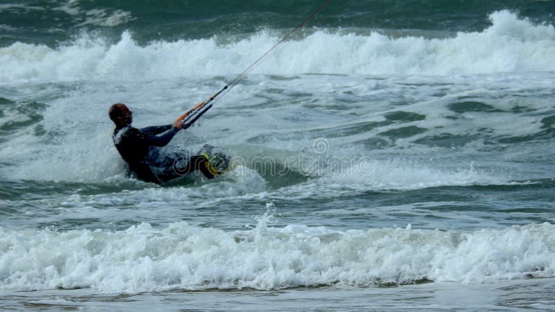 Mediterranean Sea. Israel. The coast near Haifa. The sea is storming. But there are daredevils who fly through the waves. Using a sail. Mediterranean Sea. Israel. The coast near Haifa. The sea is storming. But there are daredevils who fly through the waves. Using a sail.