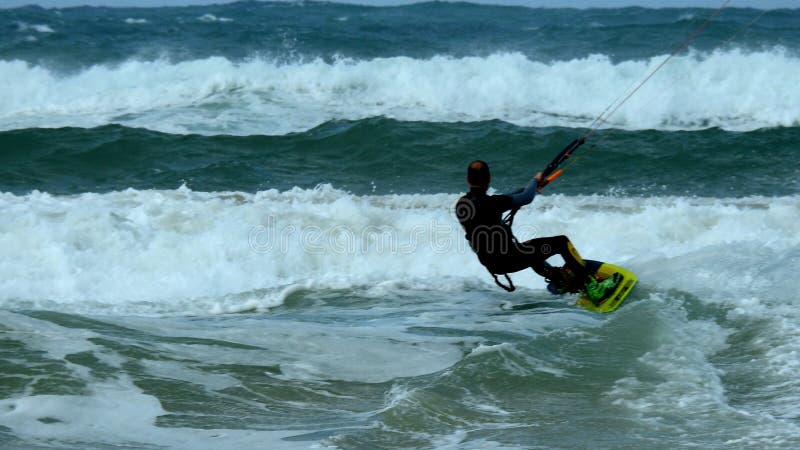 Mediterranean Sea. Israel. The coast near Haifa. The sea is storming. But there are daredevils who fly through the waves. Using a sail. Mediterranean Sea. Israel. The coast near Haifa. The sea is storming. But there are daredevils who fly through the waves. Using a sail.