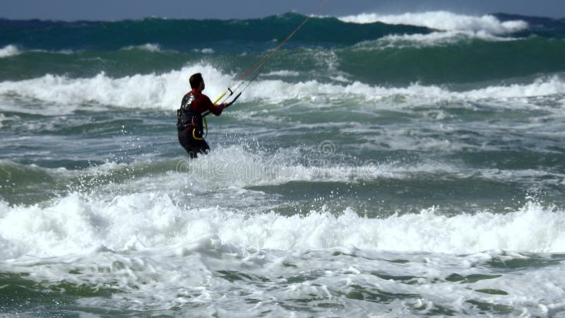 Mediterranean Sea. Israel. The coast near Haifa. The sea is storming. But there are daredevils who fly through the waves. Using a sail. Mediterranean Sea. Israel. The coast near Haifa. The sea is storming. But there are daredevils who fly through the waves. Using a sail.