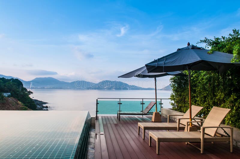 Infinity edge pool with beach chair and umbrella beautiful ocean