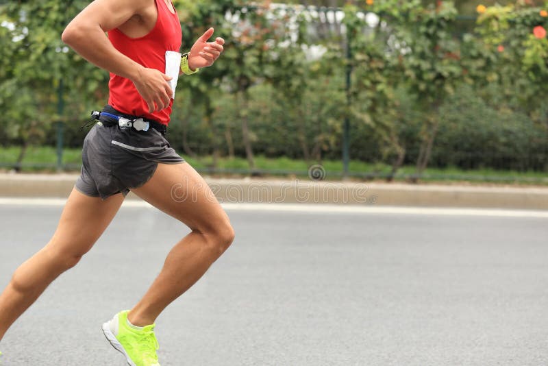 Marathon runner running on city road. Determined jogger stock images, royalty-free photos and pictures