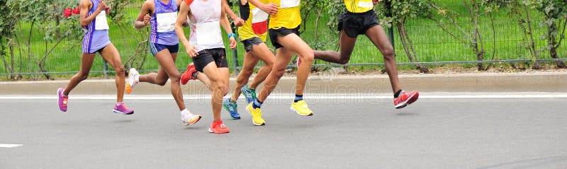Marathon runners running on city road. Determined jogger stock images, royalty-free photos and pictures
