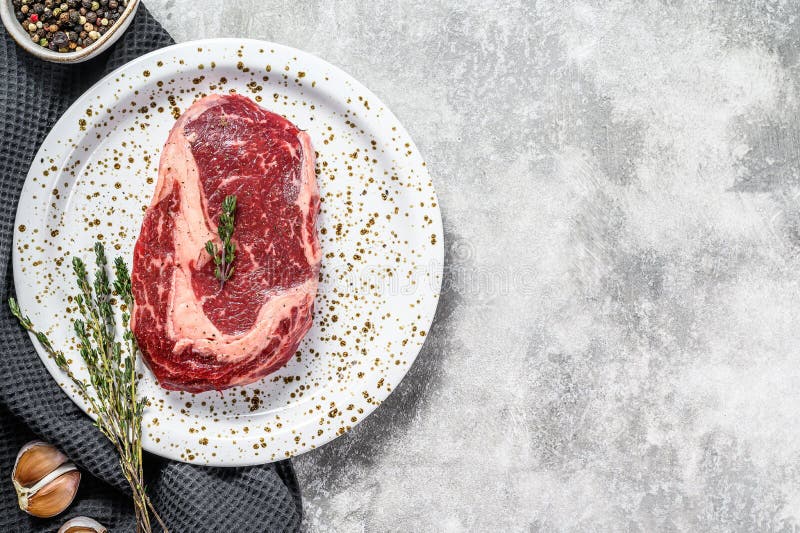 Marbled beef fillet steak. Raw rib eye, ribeye. gray background. top view. Copy space stock photo Marbled beef fillet steak. Raw rib eye, ribeye. gray background. top view. Copy space stock photo