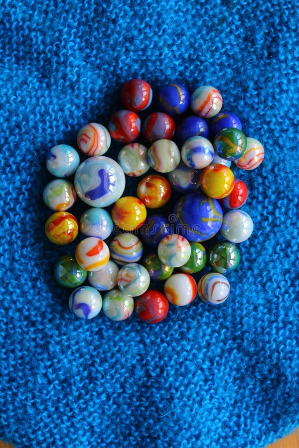 Marbles colourful in group on blue fabric background royalty free stock image Marbles colourful in group on blue fabric background royalty free stock image