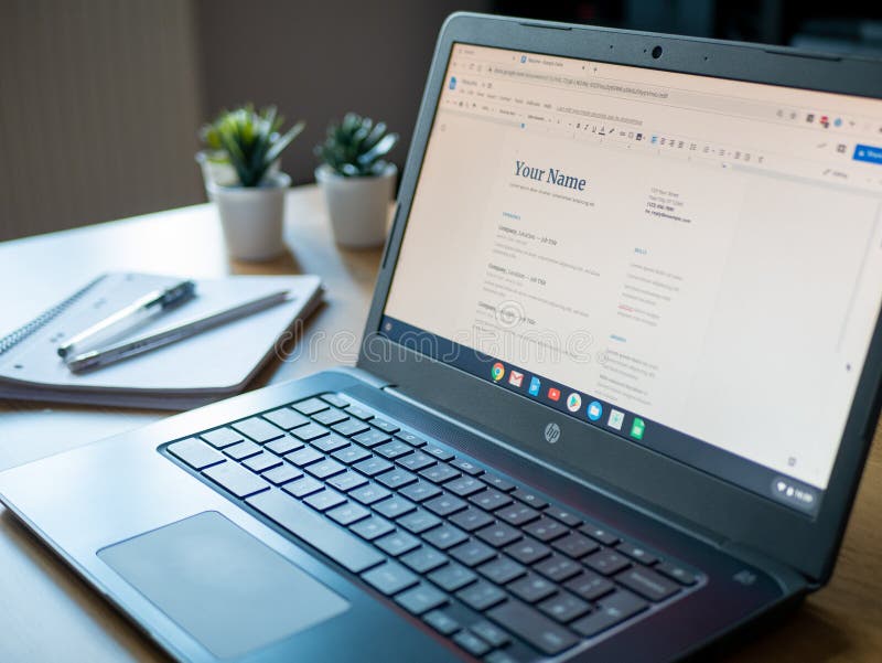 March 2020, UK Personal Document CV on screen on laptop at home with notepad royalty free stock photo