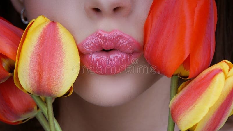 8 march women`s day. Woman with tulips kiss. Kissing. Lips and flovers close up.