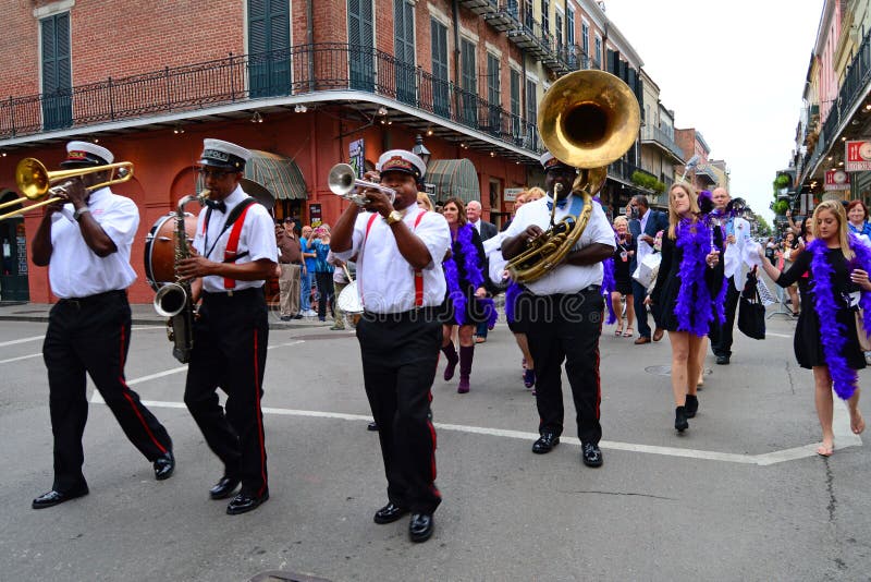 A second line march leads revelers through the French Quarter of New Orleans. A second line march leads revelers through the French Quarter of New Orleans